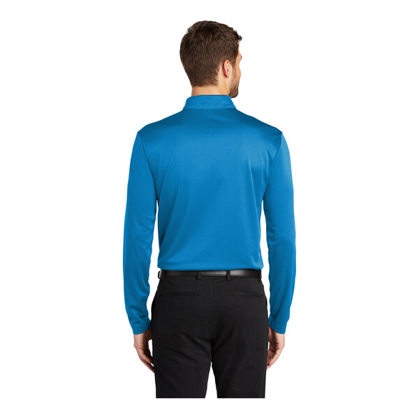 A man wearing a brilliant blue Port Authority long sleeve polo shirt.