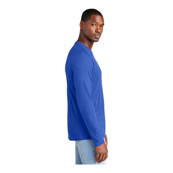 A man wearing a District deep royal blue long sleeve T-shirt.