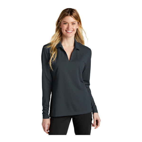 A woman wearing a black Nike long sleeve polo shirt.