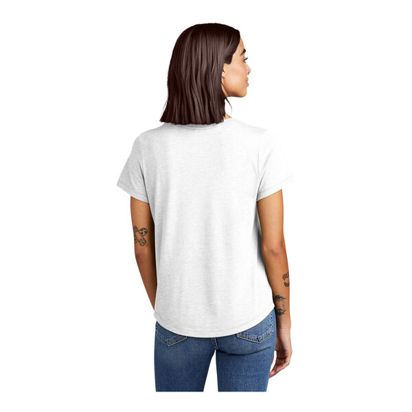 The back of a woman wearing a white AllMade short sleeve tee with a scoop neck.