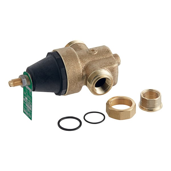 A close-up of a Watts brass water pressure reducing valve with black and brass fittings.