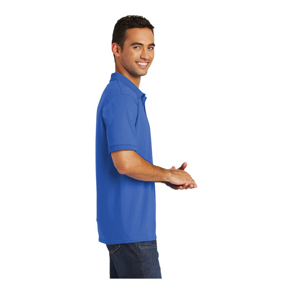 A man wearing a royal blue Port & Company polo shirt.