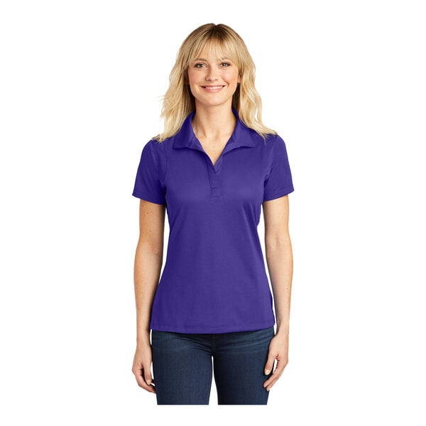 A woman wearing a purple Sport-Tek short sleeve polo shirt.