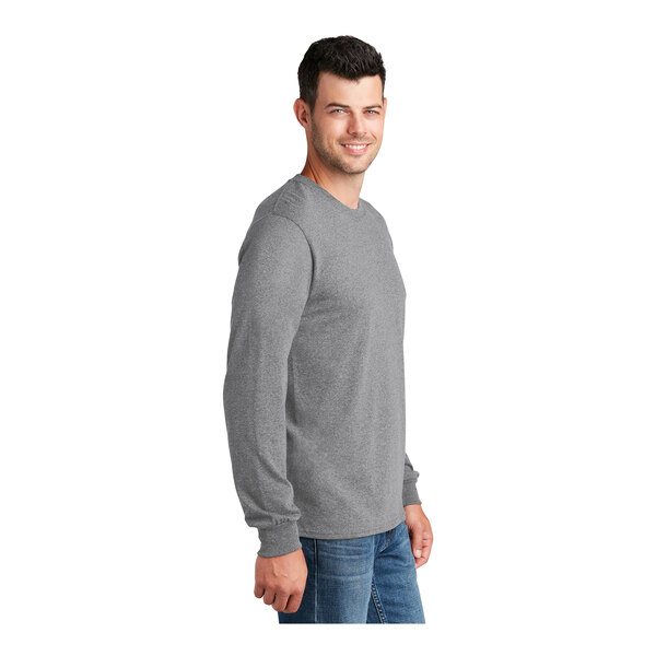 A man wearing a Port & Company long sleeve t-shirt in athletic heather.