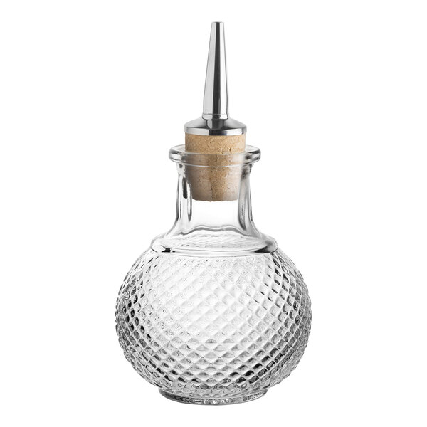 A Utopia from Steelite International Dante round glass bitters bottle with a silver dasher spout on a table.
