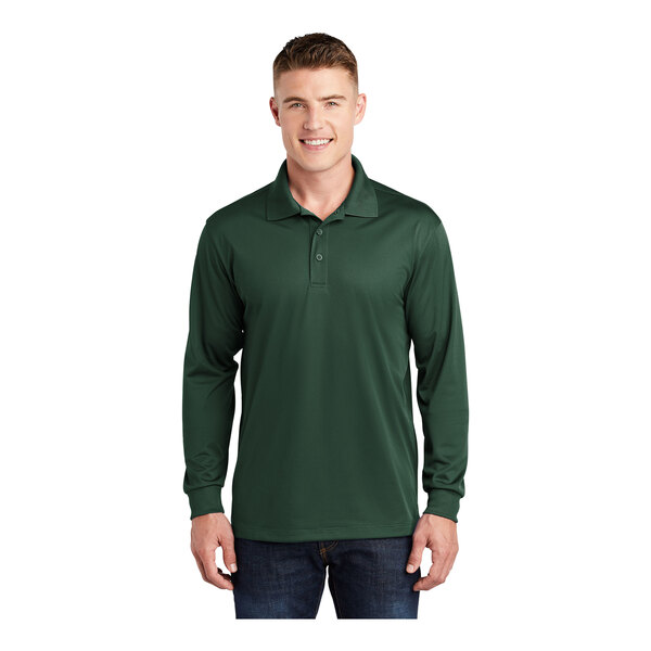 A man wearing a forest green Sport-Tek long sleeve polo shirt.