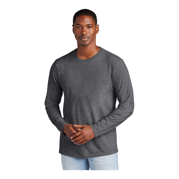 A man wearing a heathered charcoal long sleeve T-shirt.