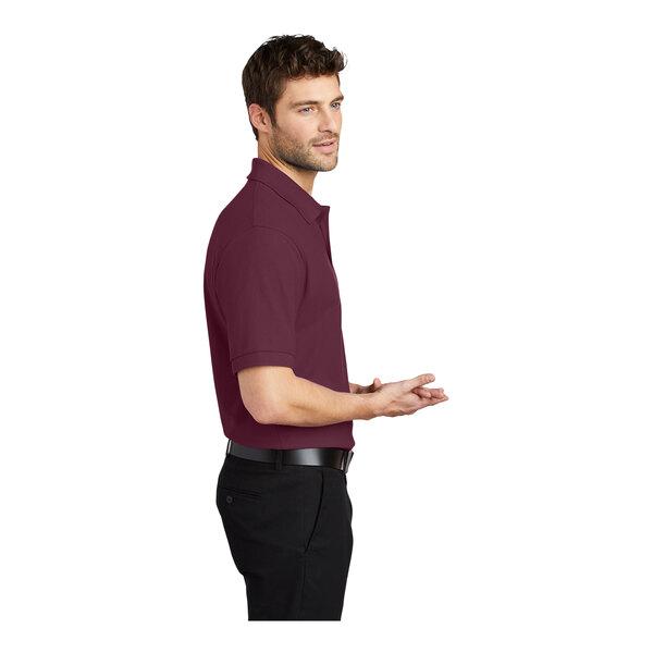 A man in a maroon Port Authority® silk touch polo shirt.