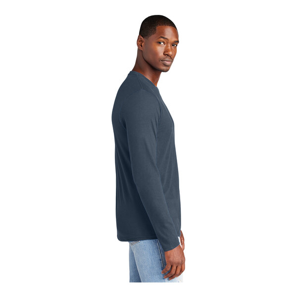 A person wearing a navy District long sleeve t-shirt.