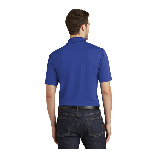 A man wearing a Port Authority True Royal blue polo shirt.