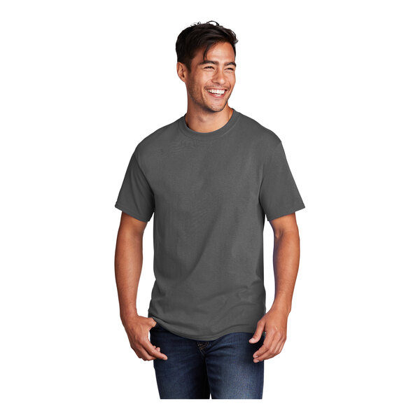 A man smiling and wearing a charcoal Port & Company short sleeve t-shirt.