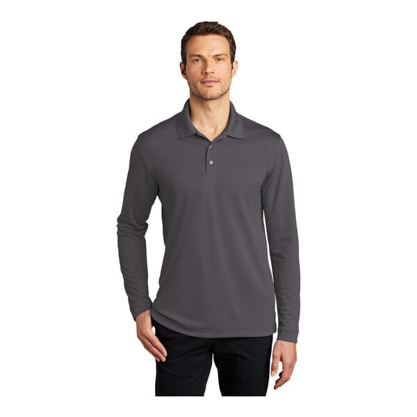 A man wearing a graphite Port Authority long sleeve polo shirt.