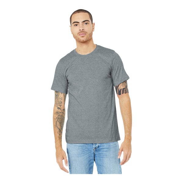 A man wearing a Bella + Canvas athletic heather short sleeve t-shirt in grey.