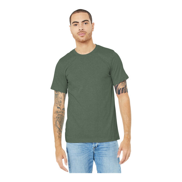 A man wearing a Bella + Canvas heather military green t-shirt and jeans.