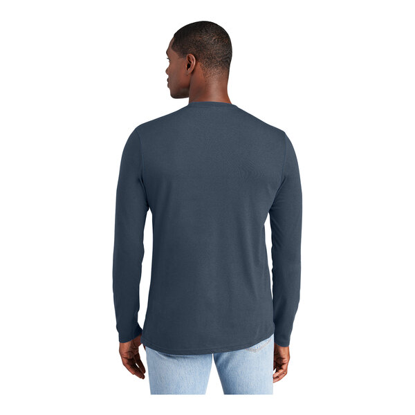 A man wearing a District navy long sleeve t-shirt.