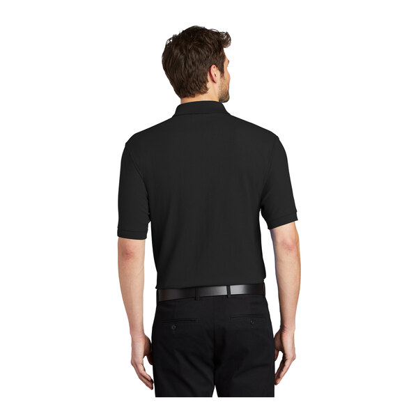 A man wearing a black Port Authority silk touch pique polo shirt.