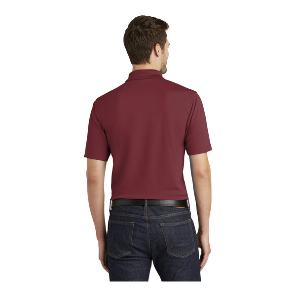 A man wearing a maroon Port Authority polo shirt.