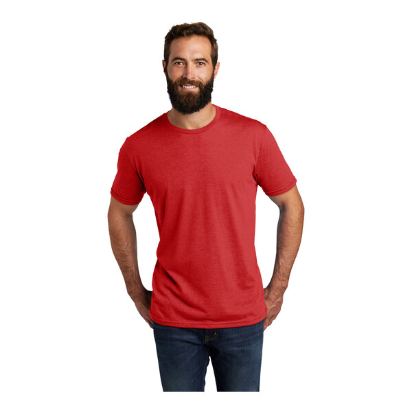 A man with a beard wearing a red AllMade Rise-Up T-shirt.
