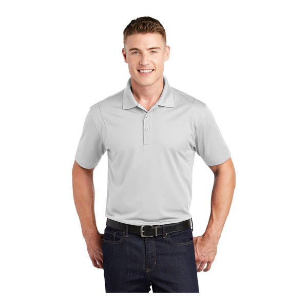 A man wearing a white Sport-Tek moisture-wicking polo shirt.