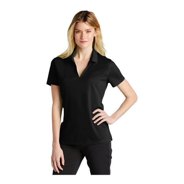 A woman wearing a black Nike polo shirt.