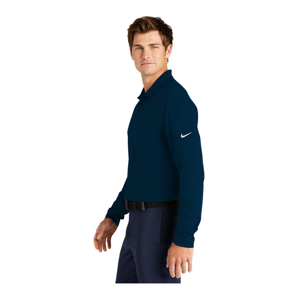 A close-up of a navy blue Nike Dri-Fit polo shirt on a man.