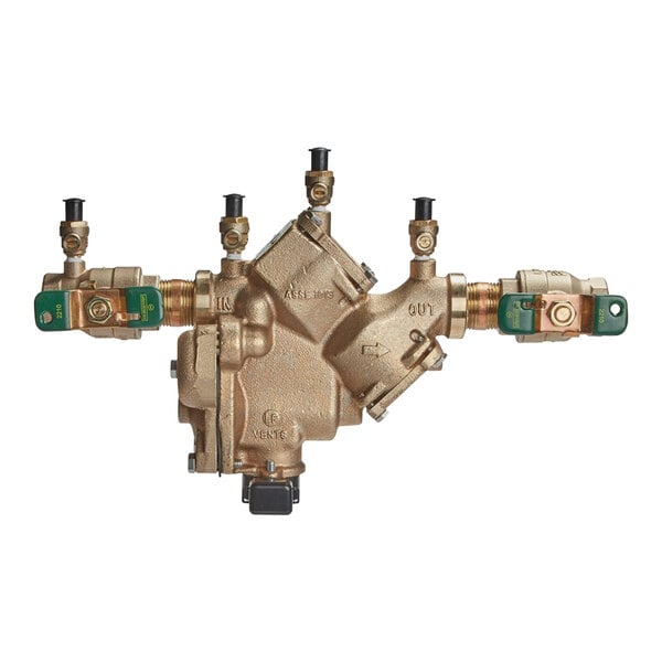 A close-up of a brass Watts Reduced Pressure Zone Assembly with three green valves.