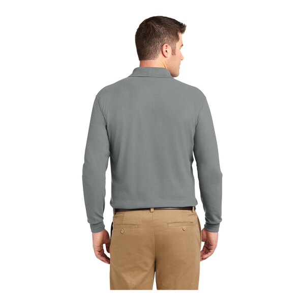 A man wearing a Port Authority cool gray long sleeved polo shirt.