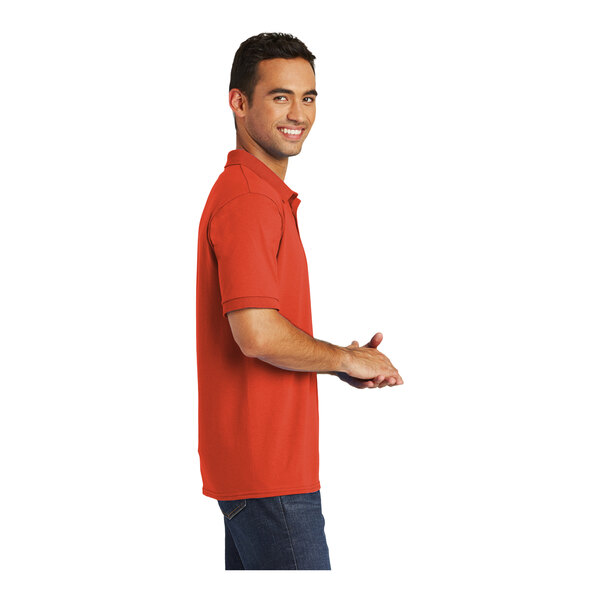 A man wearing an orange Port & Company polo shirt.