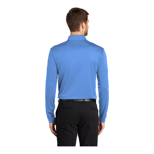 A man wearing a Carolina blue Port Authority long sleeve polo shirt.