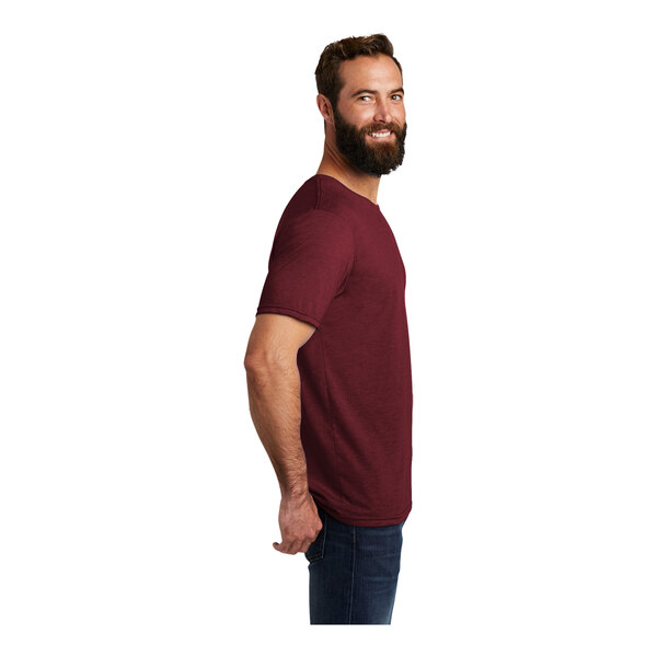 A man with a beard wearing a maroon AllMade short sleeve t-shirt.