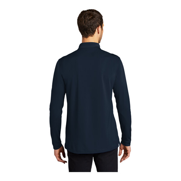 A man wearing a navy blue long sleeved Port Authority polo shirt.
