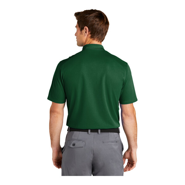 A man wearing a Nike Gorge Green polo shirt.