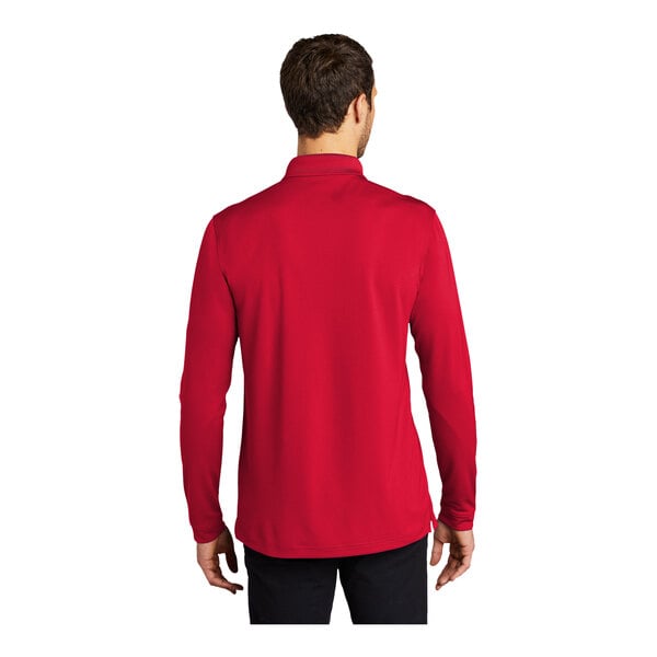A man wearing a rich red long sleeve Port Authority polo shirt.