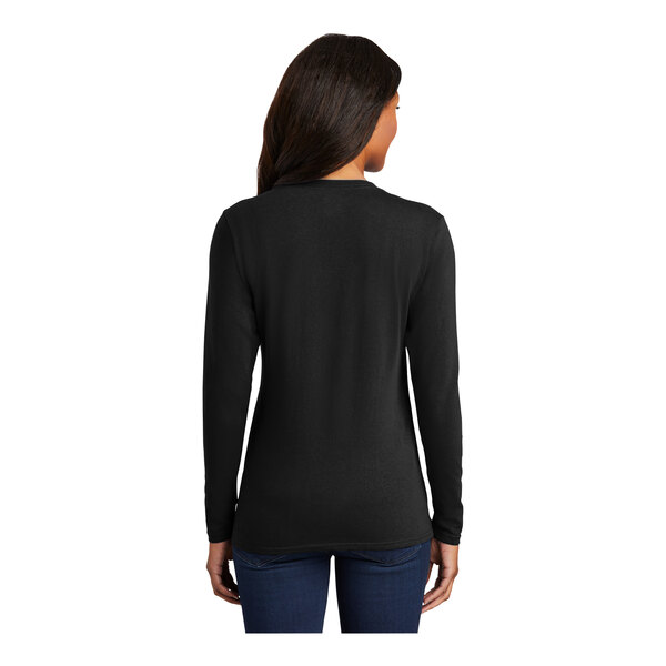 A woman wearing a black Port & Company long sleeve t-shirt.