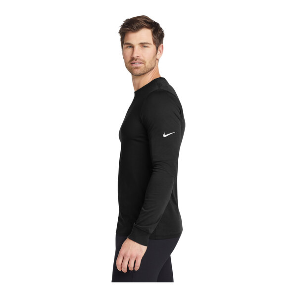A person wearing a black Nike Dri-FIT long sleeve shirt.