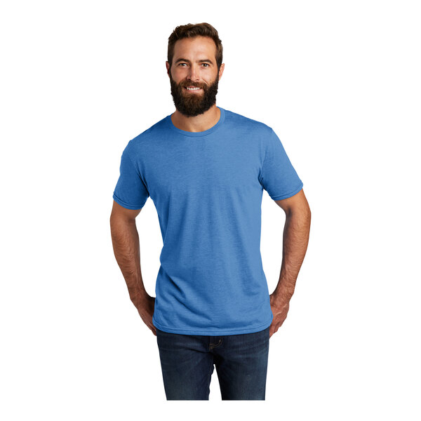 A man with a beard wearing an azure blue AllMade T-shirt.