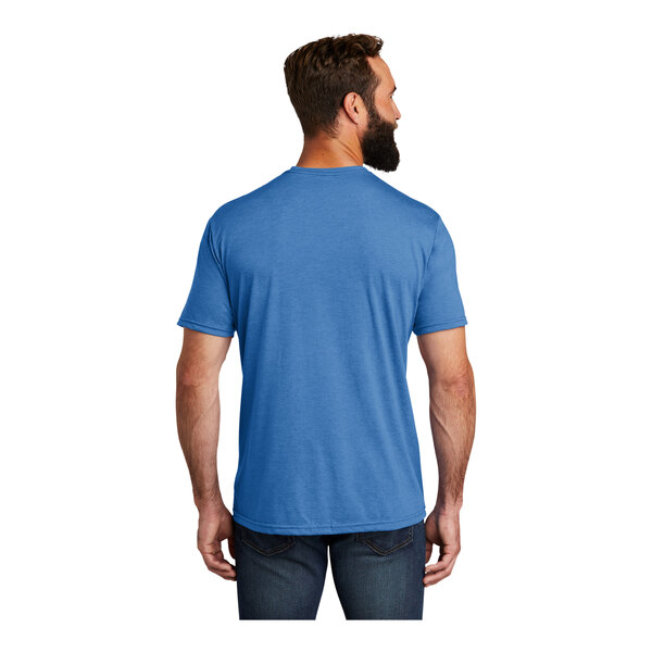 A man wearing an azure blue AllMade short sleeve t-shirt.
