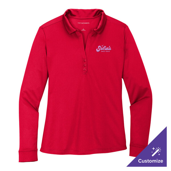 A red Port Authority women's long sleeve polo shirt with an embroidered logo on the counter.