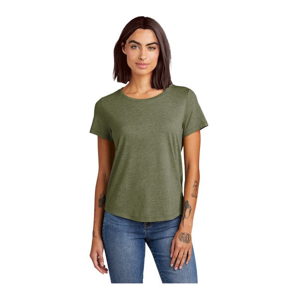 A woman wearing a soft olive green tri-blend short sleeve tee with a scoop neck.