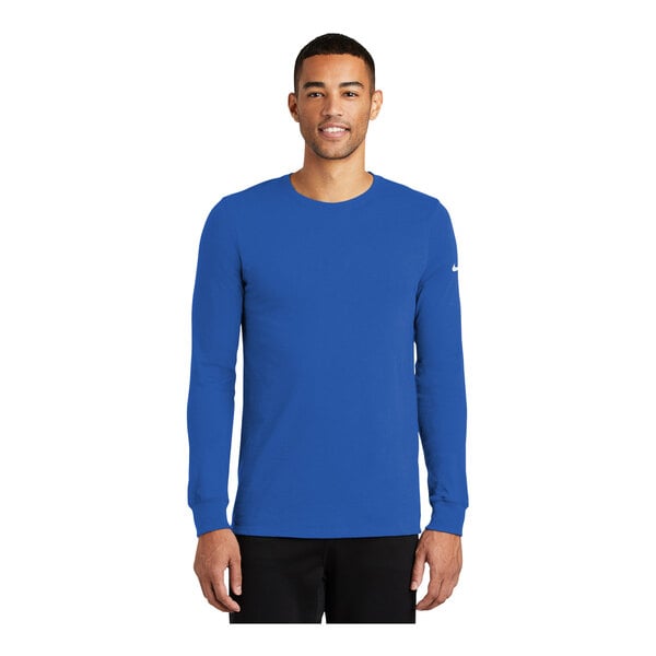 A man wearing a blue Nike Dri-FIT long sleeve t-shirt with a crew neck.