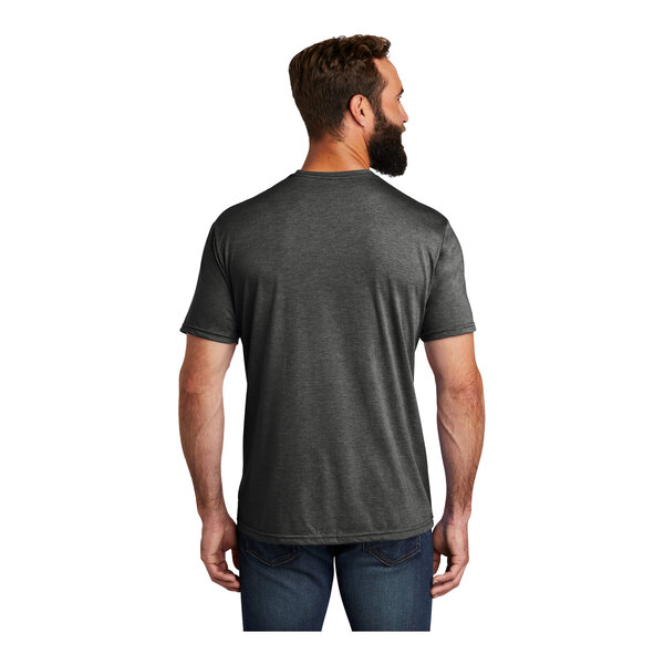 A man wearing an AllMade Terrain grey t-shirt.