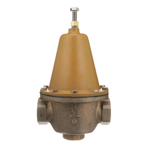 A brown and gold metal Watts water pressure reducing valve with a yellow cap.