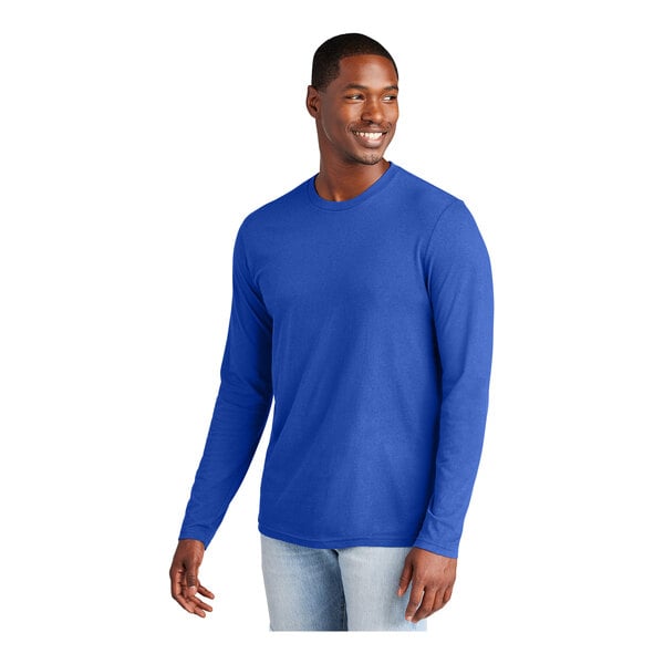 A man wearing a deep royal blue District long sleeve t-shirt.