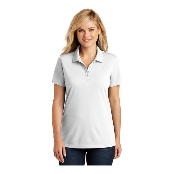 A woman wearing a white Port Authority Dry Zone polo shirt with a collar.