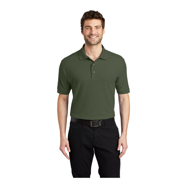 A man wearing a Port Authority® clover green polo shirt in a pique fabric.