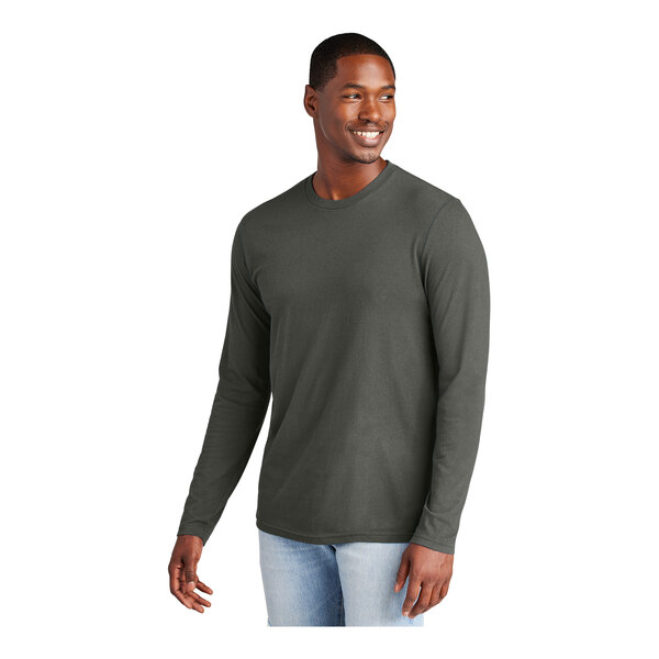 A man wearing a District Deepest Gray long sleeve t-shirt made from soft cotton.