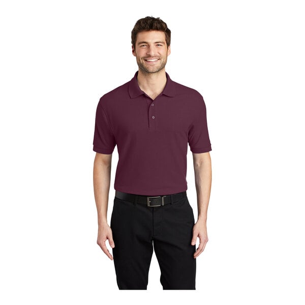 A man wearing a maroon Port Authority silk touch pique polo shirt.