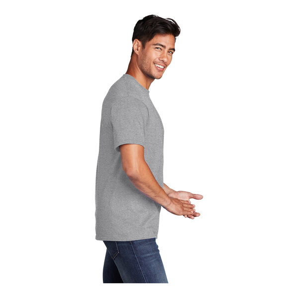 A man wearing a Port & Company athletic heather grey short sleeve t-shirt smiling.