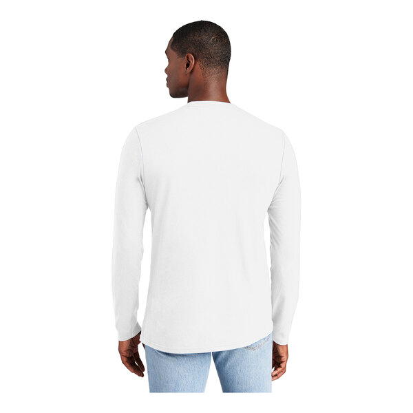 A man wearing a white District long sleeve T-shirt.