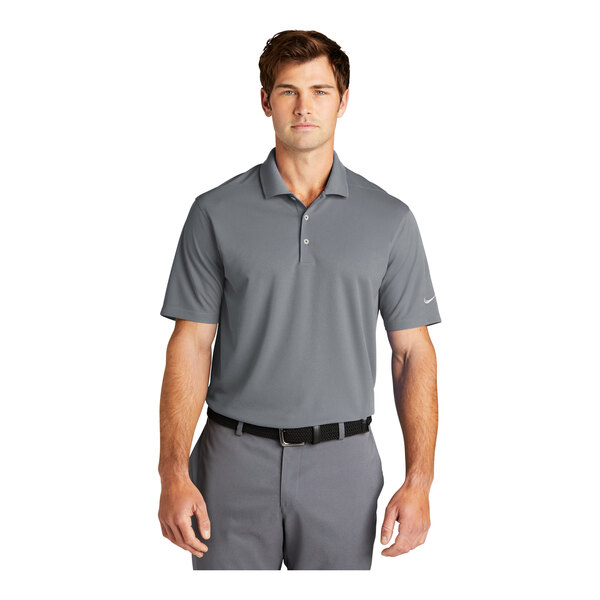 A man wearing a grey Nike Dri-Fit polo shirt with a collar.